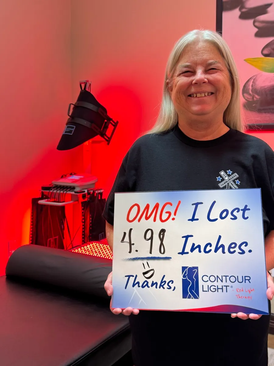 Contour Light client holding a sign: “OMG! I lost 4.98 inches. Thanks, Contour Light.”
